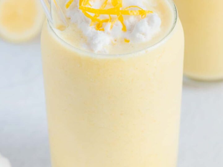 Two glasses of lemon smoothie with a spoon.