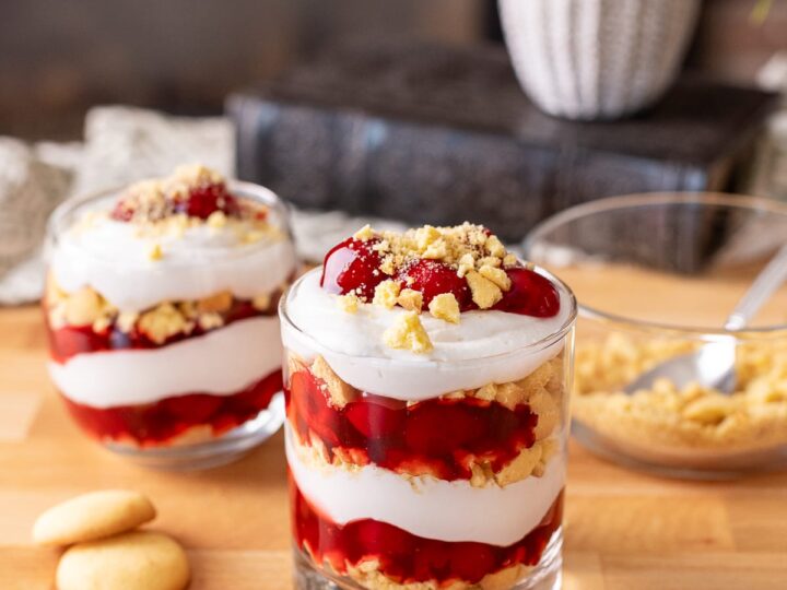 No-bake dairy free cherry cheesecake cups on a butcher block.