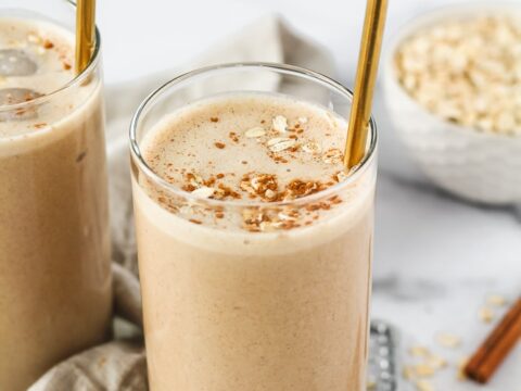 Two glasses of smoothie with cinnamon and oats.