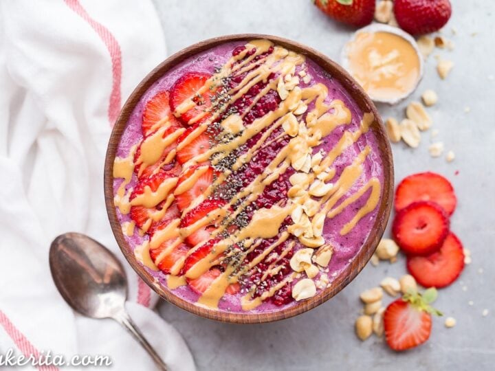 A bowl of strawberry and peanut butter smoothie bowl.