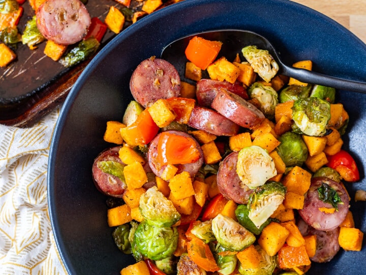 Overhead photo of sheet pan sausage and veggies with roasted brussels sprouts.