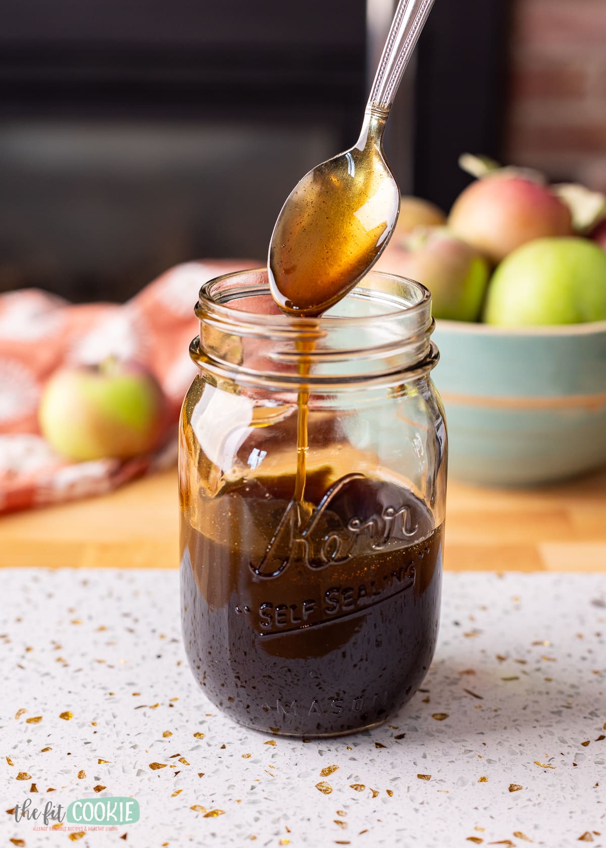 Starbucks copycat apple brown sugar syrup in a jar with a spoon in it.