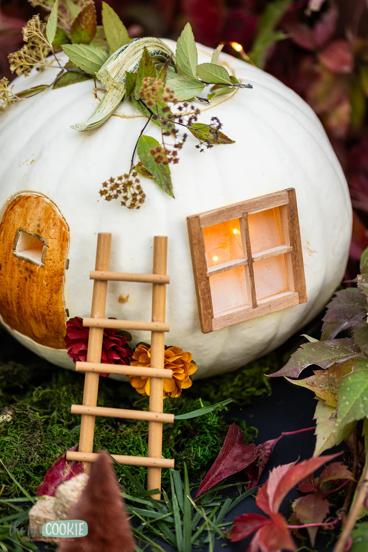A fairy house made with a real white pumpkin. 