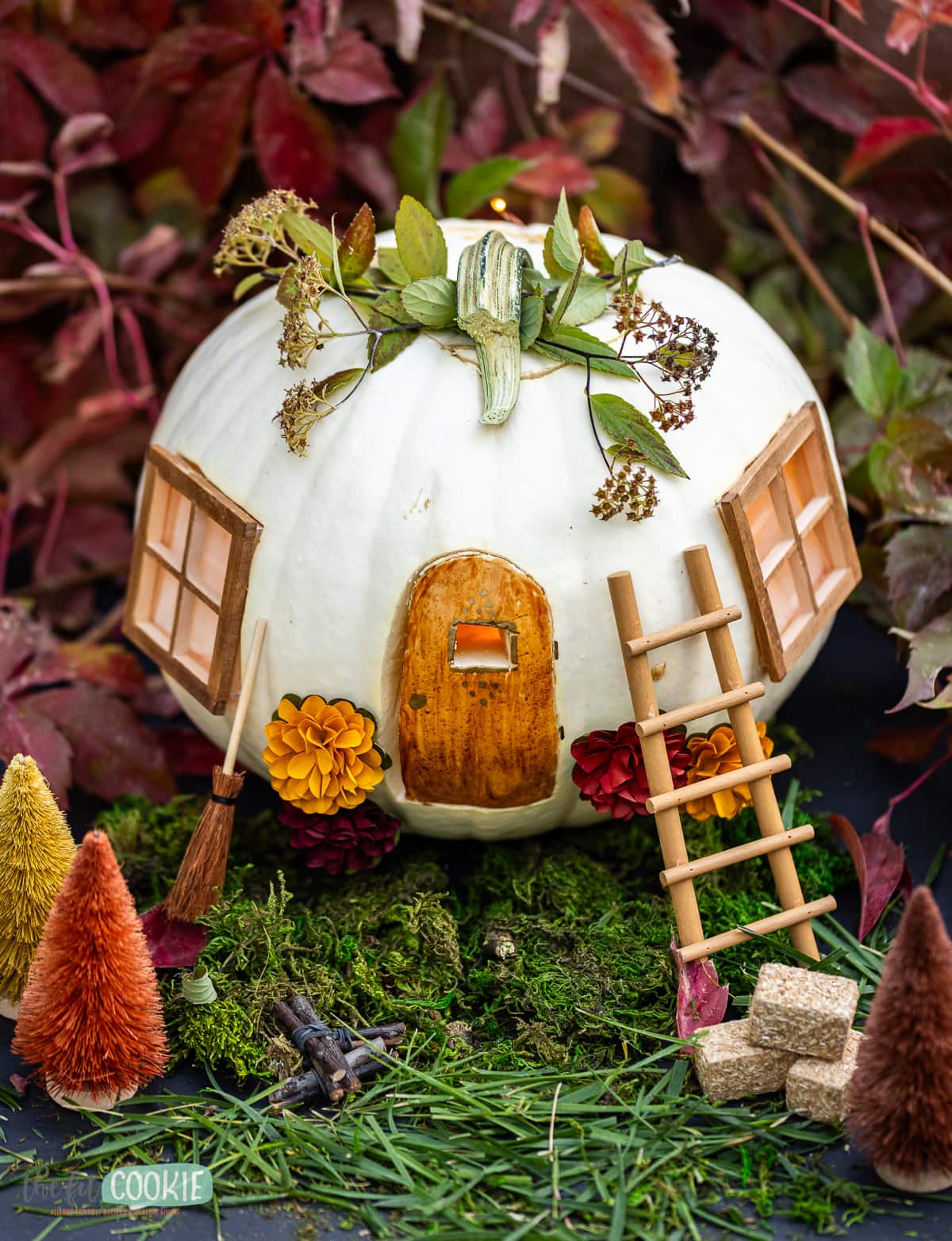 A white pumpkin decorated to be a fairy house.