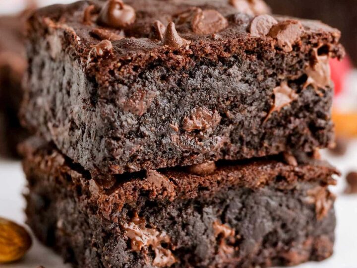A stack of chocolate brownies stacked on top of each other.