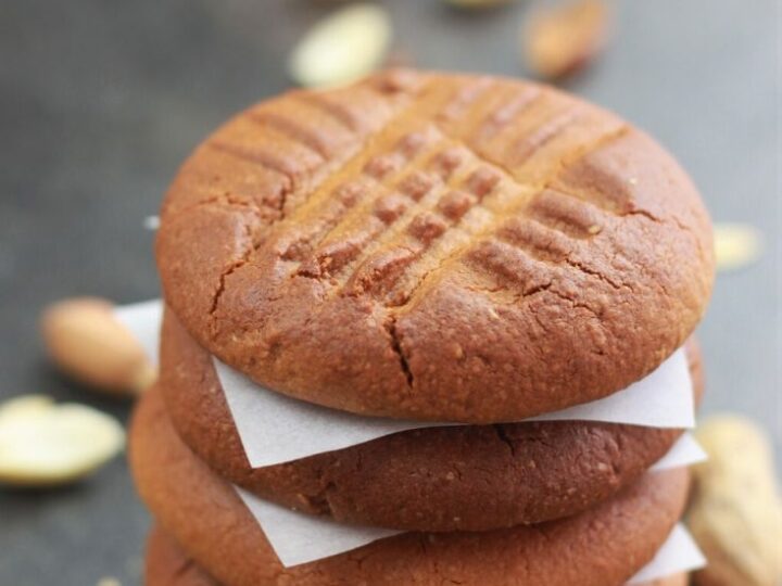 Peanut butter cookies stacked on top of each other.
