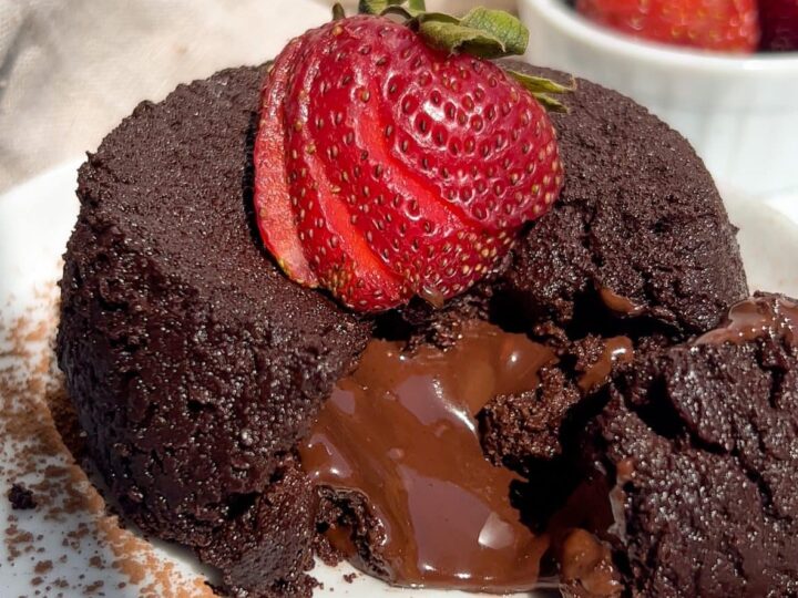 A chocolate cake with strawberries on a plate.