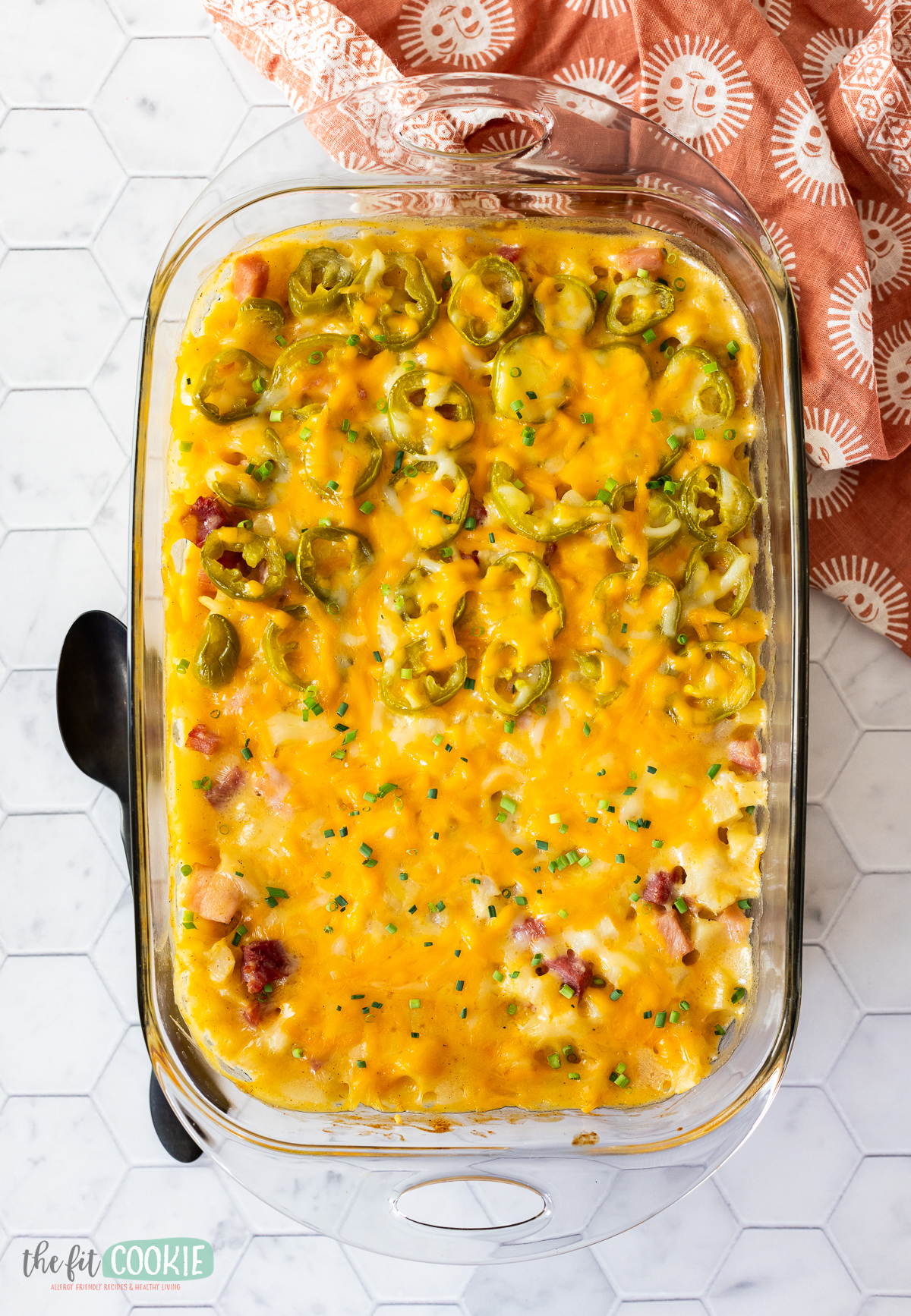 A dairy-free casserole dish filled with cheesy potatoes and jalapenos.