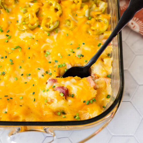 A glass casserole dish with dairy free cheesy potatoes in it.