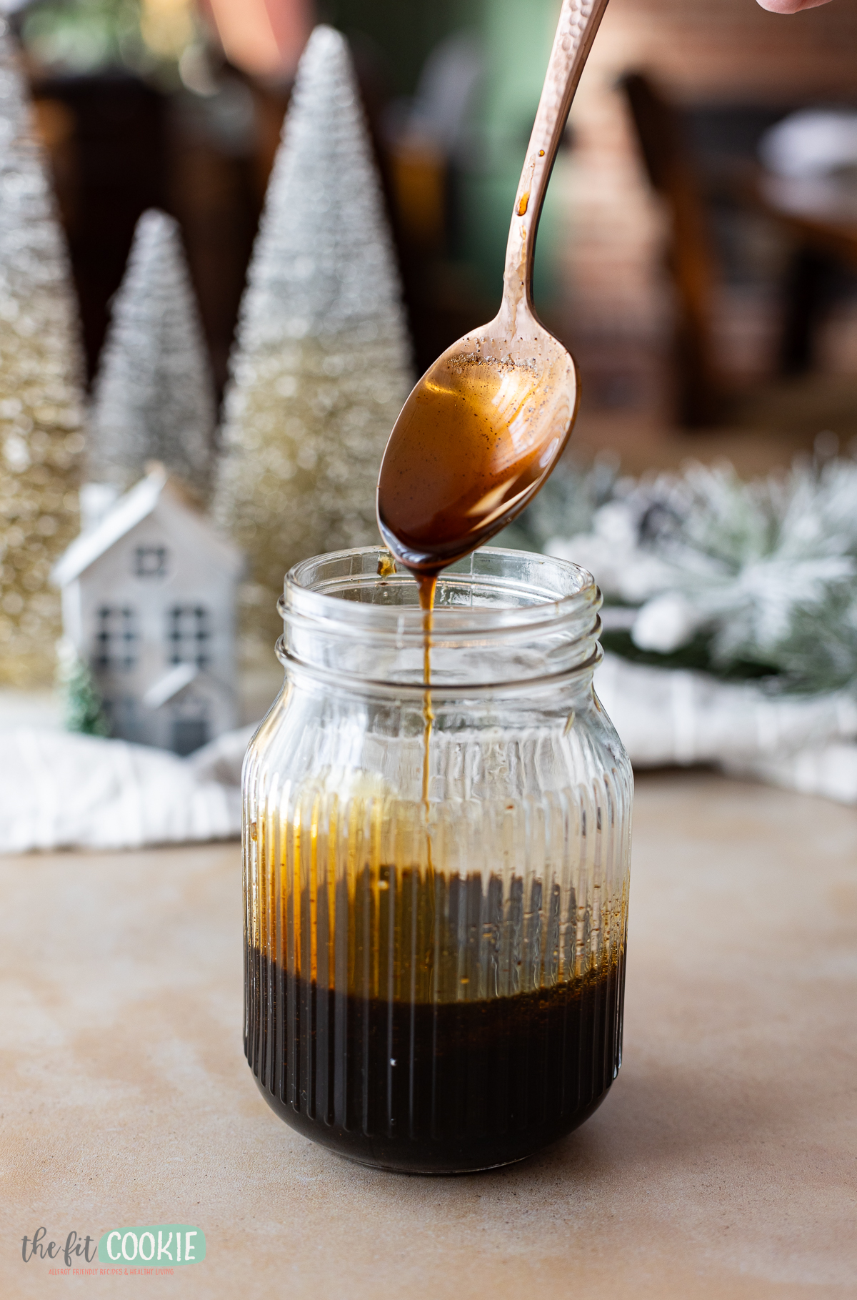 copper spoon in a jar of gingerbread syrup. 