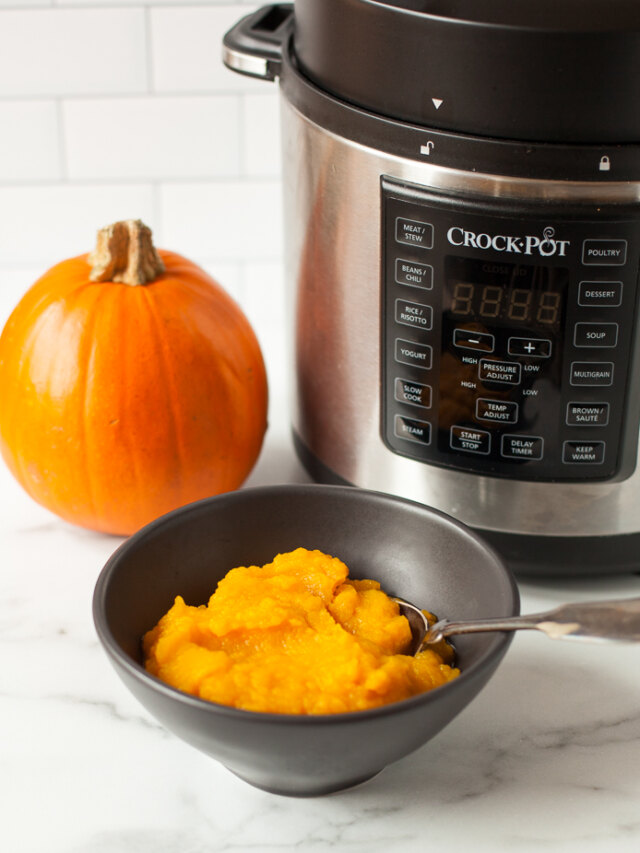 A bowl of pumpkin in front of an instant pot.