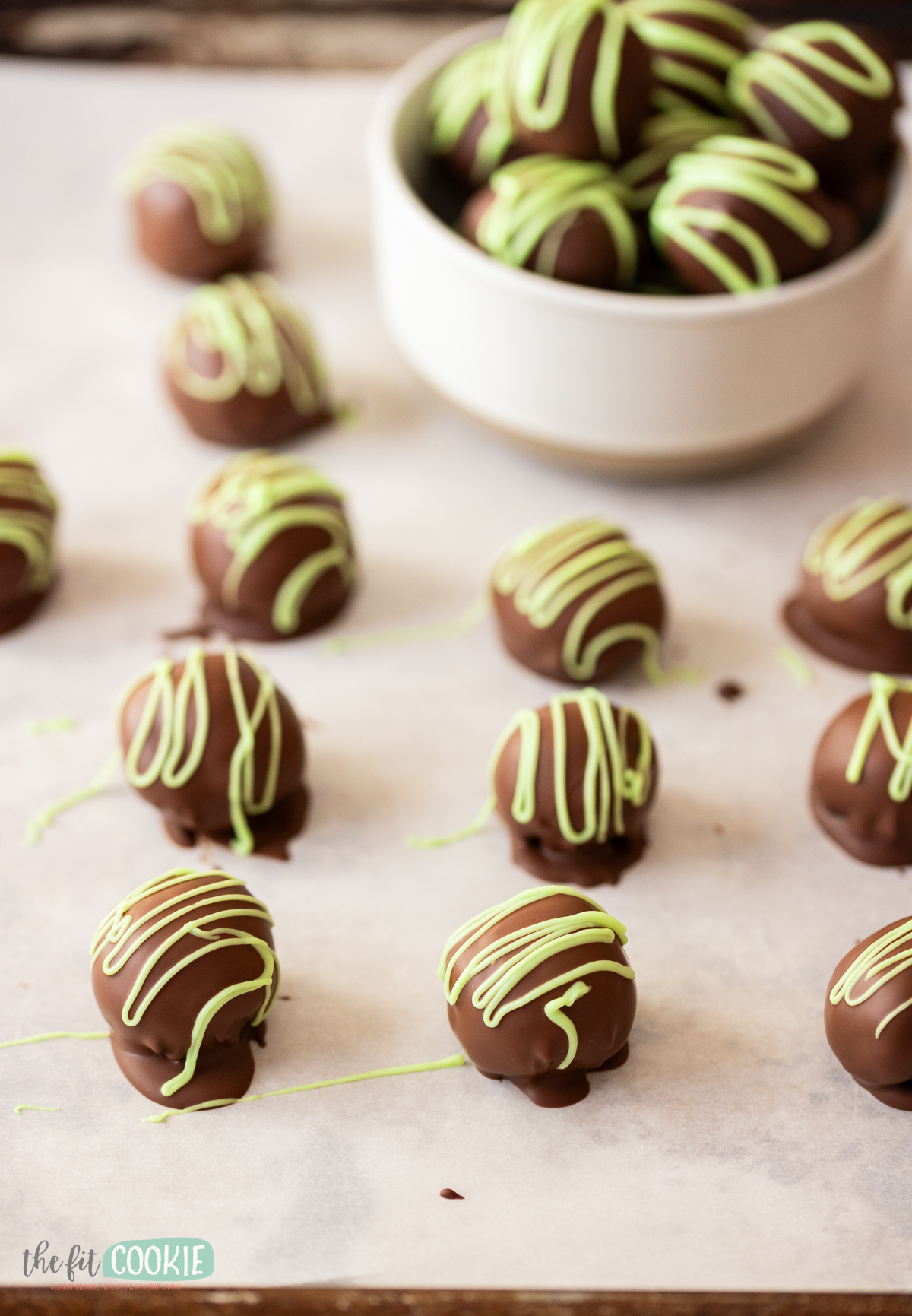 Mint Chocolate cookie truffles with green mint chocolate on a baking sheet.