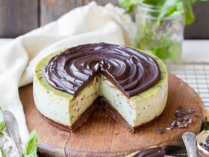 A chocolate and mint cheesecake with a slice taken out.
