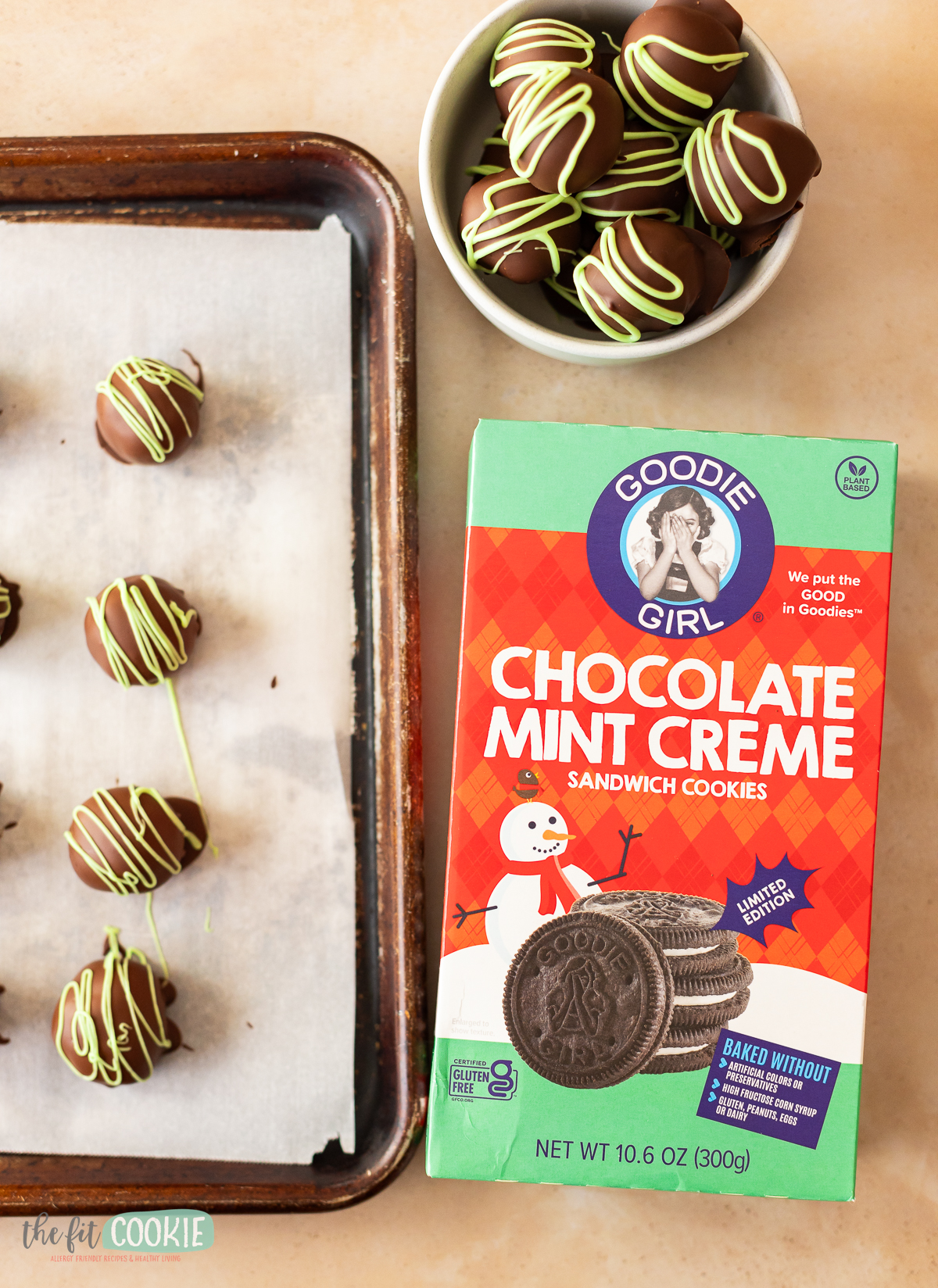Goodie girl mint cookies next to a baking sheet of mint oreo truffles.