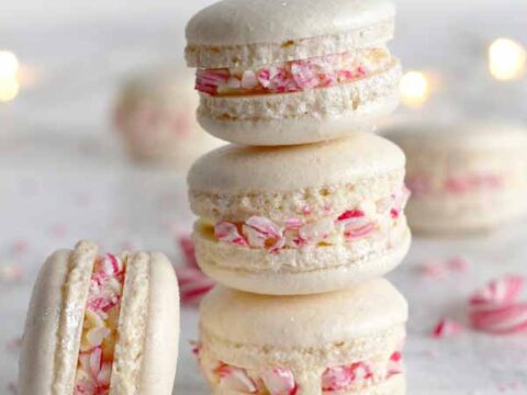 Three macarons stacked on top of each other with candy canes.