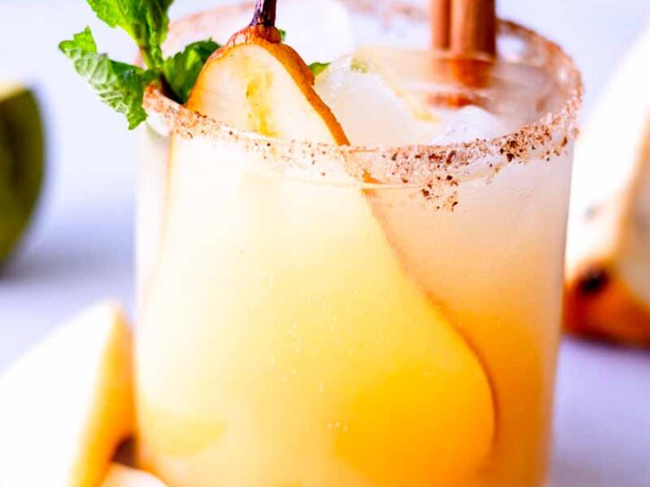 Pear margarita with cinnamon and mint garnish.