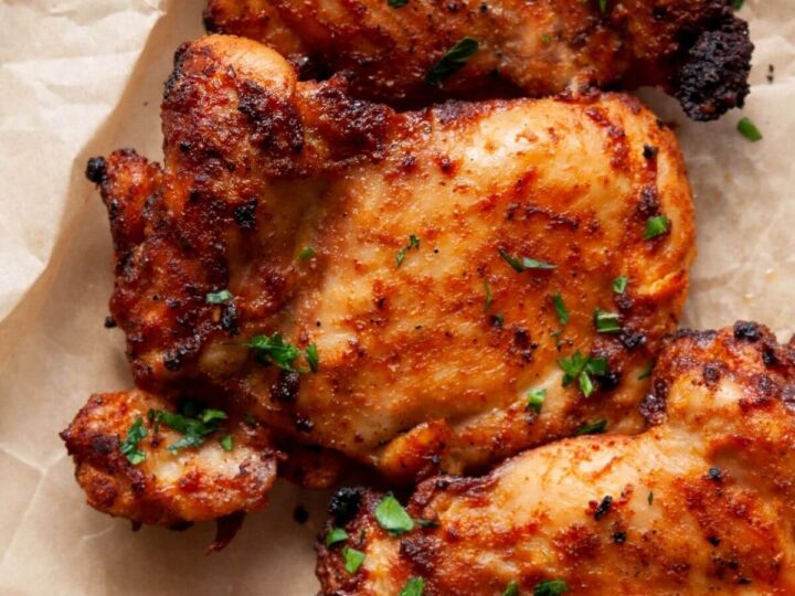 Grilled chicken breasts on a piece of paper.