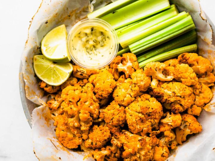 A bowl of fried cauliflower with celery and dipping sauce.