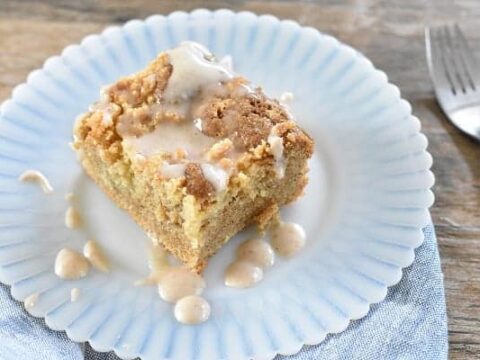 A piece of coffee cake on a plate with a fork.