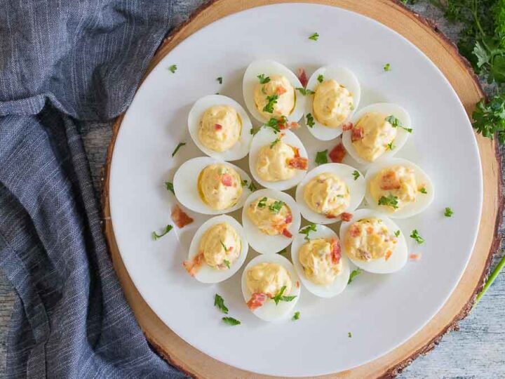 Deviled eggs on a plate with parsley.