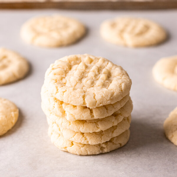 A stack of gluten free shortbread cookies on a baking sheet.