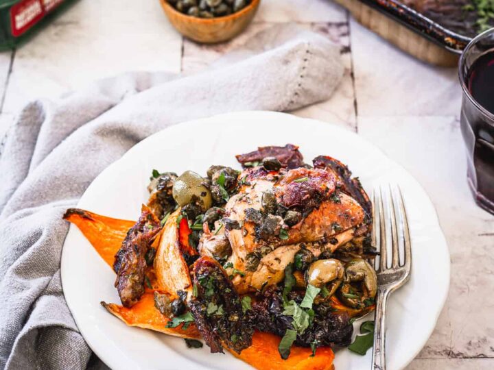 A plate with chicken and vegetables on it.