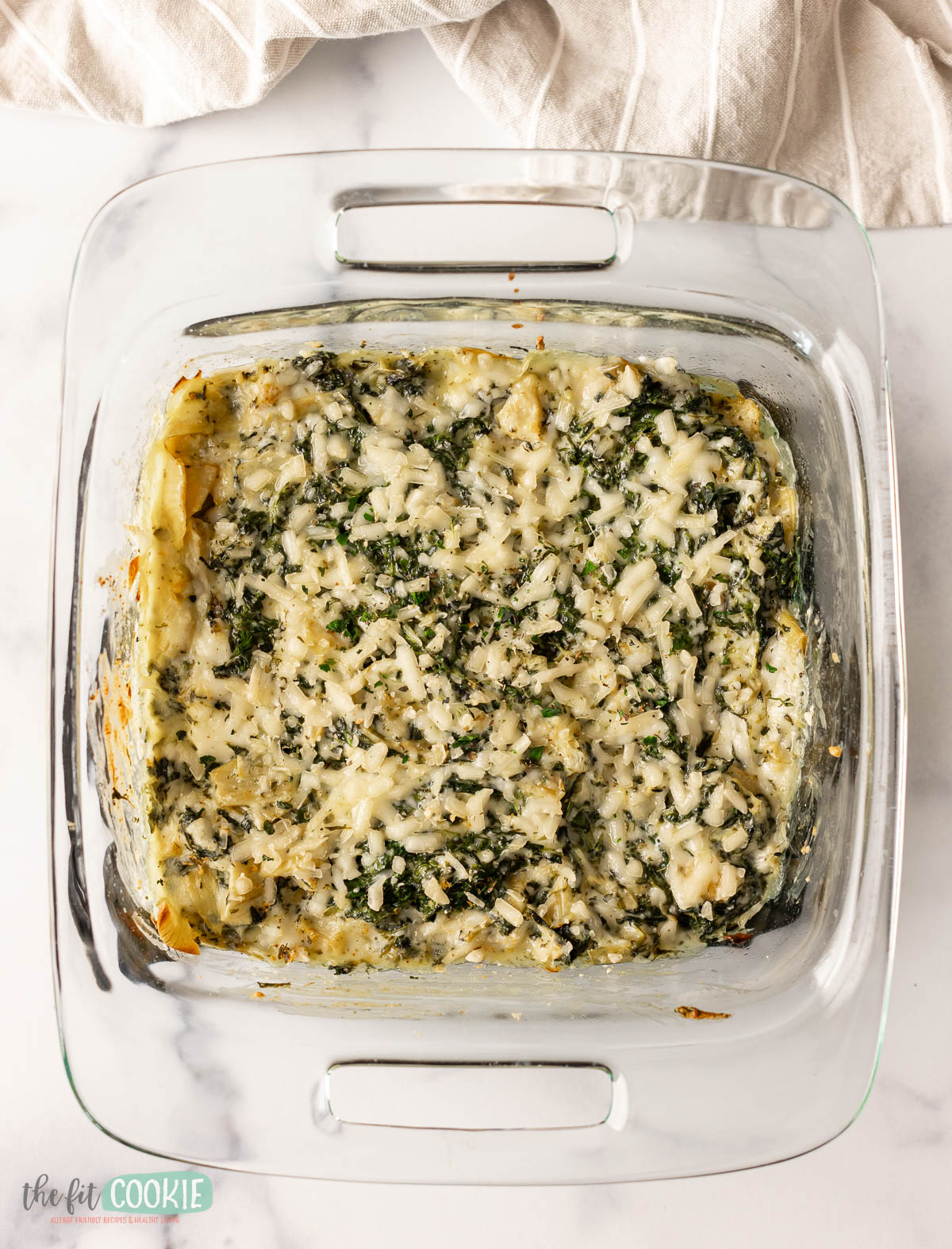 dairy free spinach artichoke dip in a glass baking dish. 
