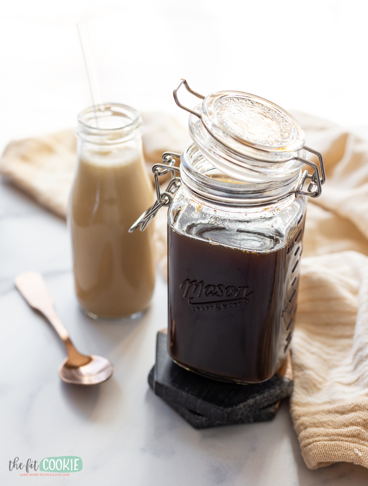 a clamp mason jar filled with chai syrup and tea concentrate. 