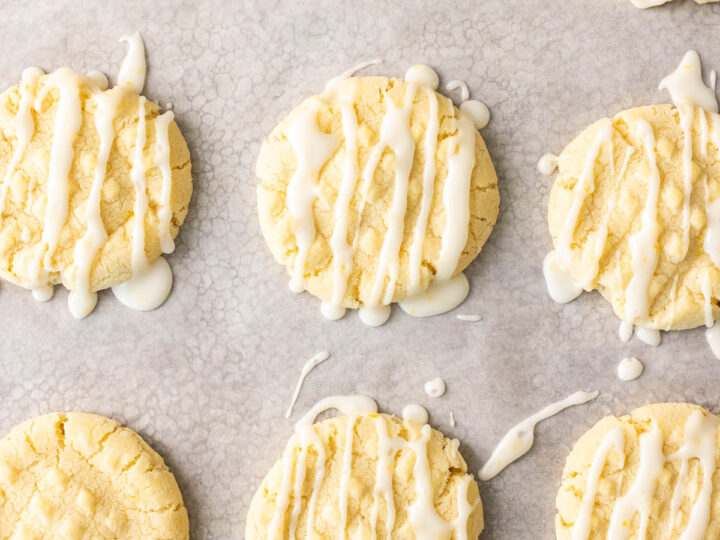 Lemon cookies with icing on a baking sheet.