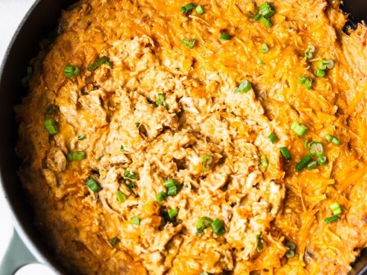 Chicken dip in a skillet with tortilla chips.