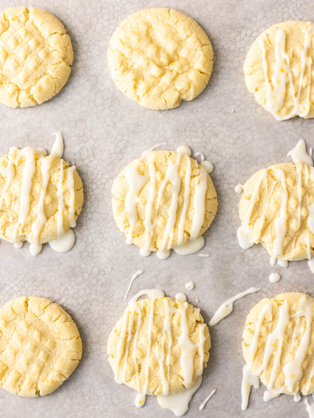 Lemon cookies with icing on a baking sheet.