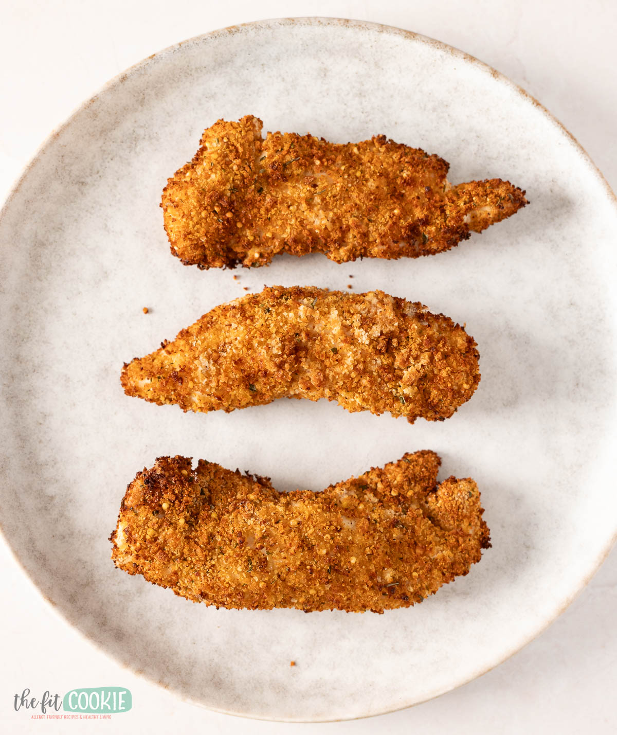 Three seasoned, air fried chicken tenders coated in homemade gluten free bread crumbs.