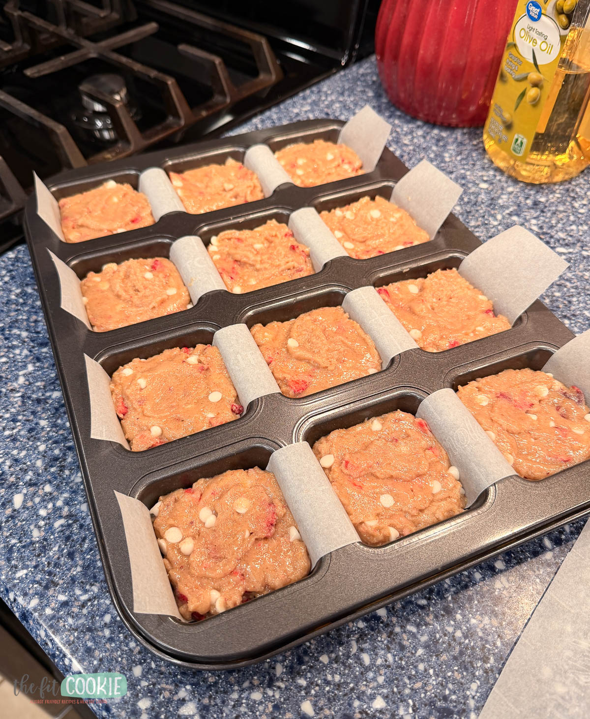 batter for white chocolate strawberry blondies in a brownie pan waiting to be baked.