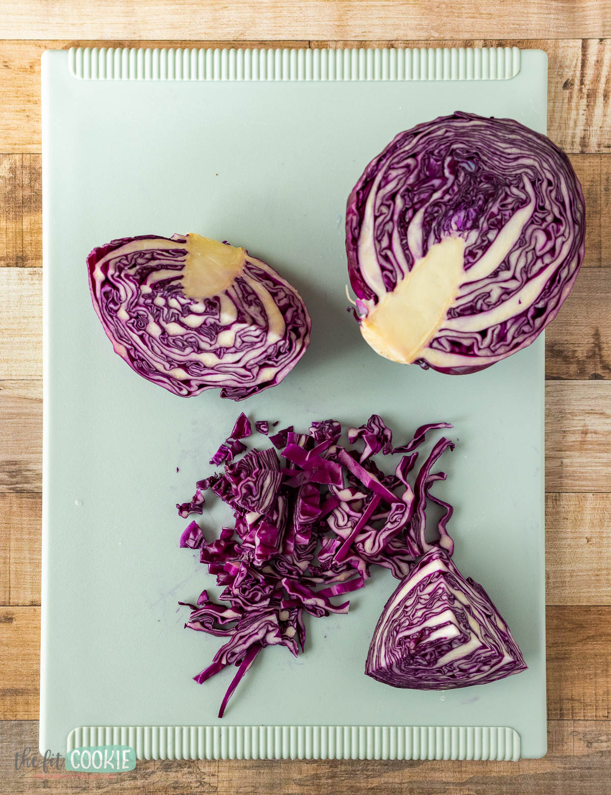 Cut and shredded red cabbage on a cutting board.