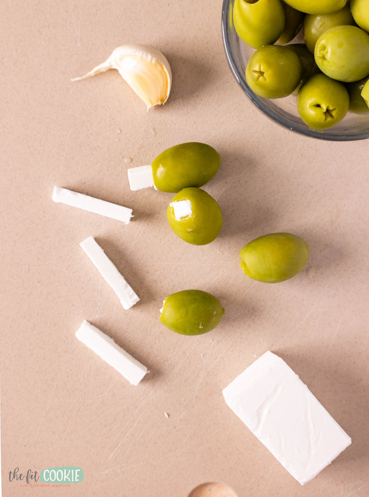 close up of olives being stuffed with vegan feta cheese.