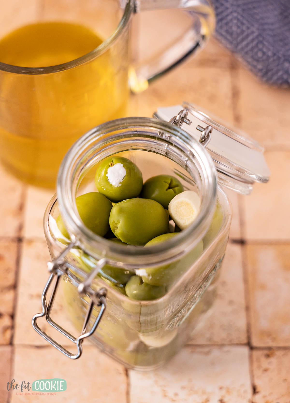 glass jar filled with dairy free feta stuffed olives waiting to be covered with brine or oil.