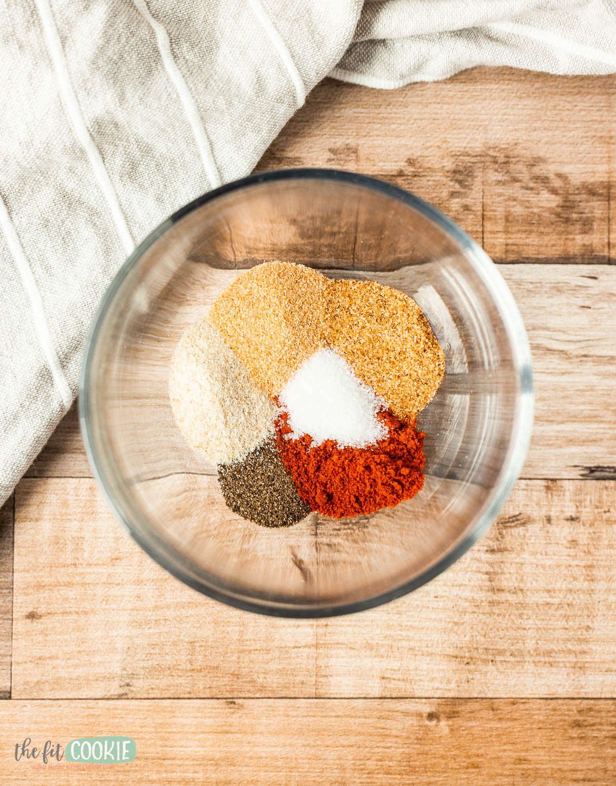 A glass bowl containing a smoky spice blend.