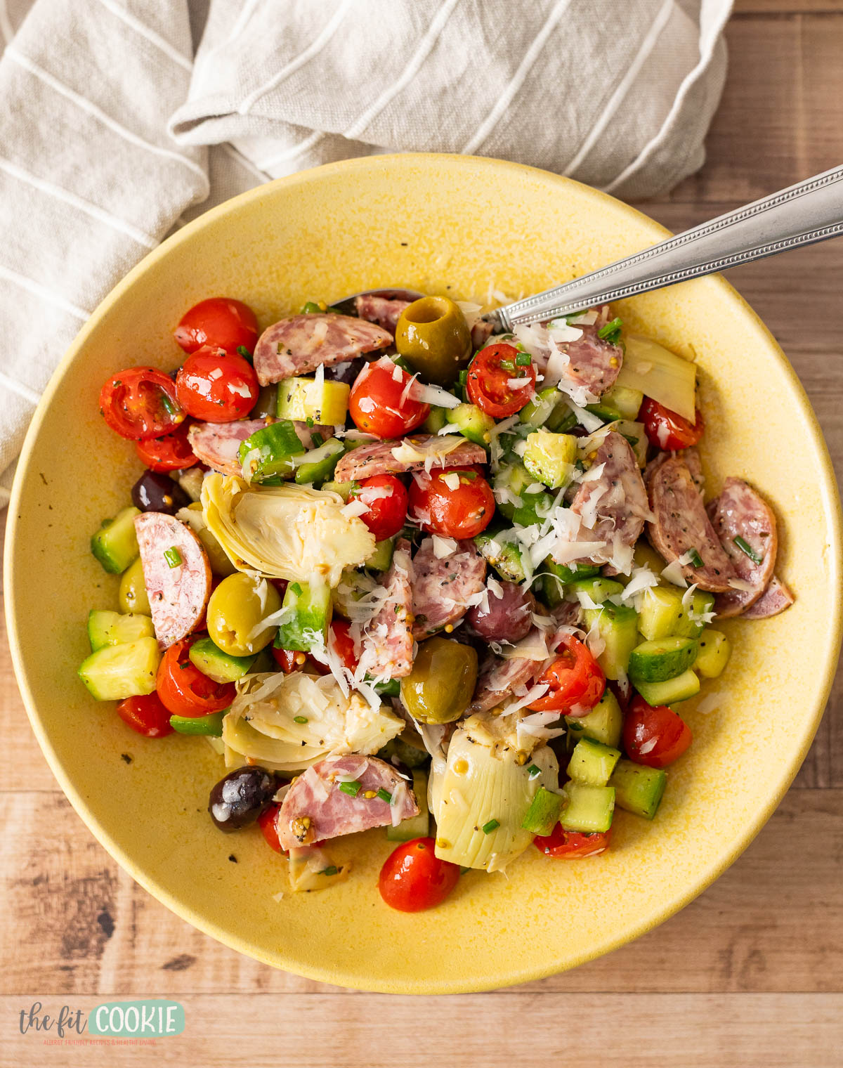 A yellow bowl of dairy free Italian Chopped Salad in a yellow bowl with a fork. 