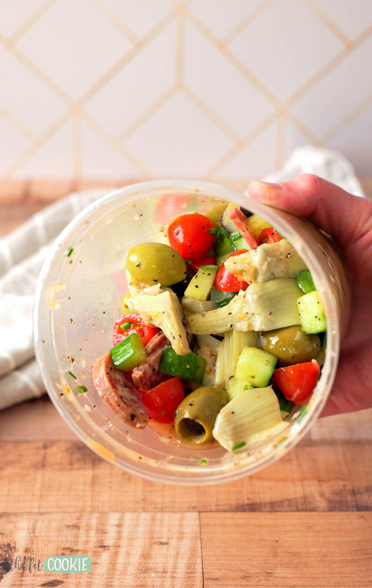 a clear deli container filled with dairy free chopped italian salad. 